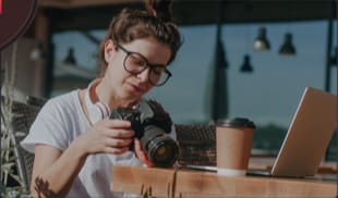 Photographer reviewing shots in a cafe